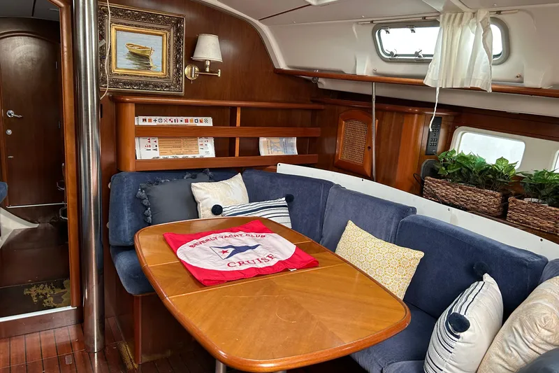 Slide: The Image of Interior of a 1998 Beneteau 411 sailboat with cozy seating and nautical decor. - 5