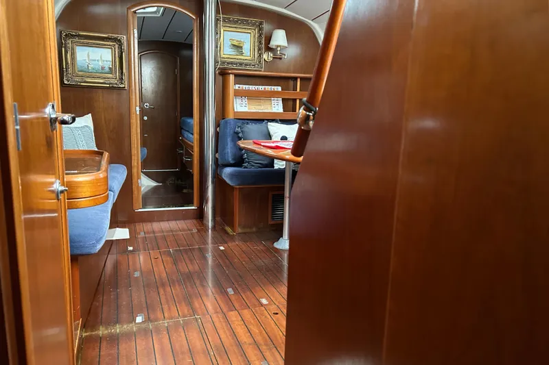 Slide: The Image of Interior of 1998 Beneteau 411 yacht with wooden finish and blue seating. - 9