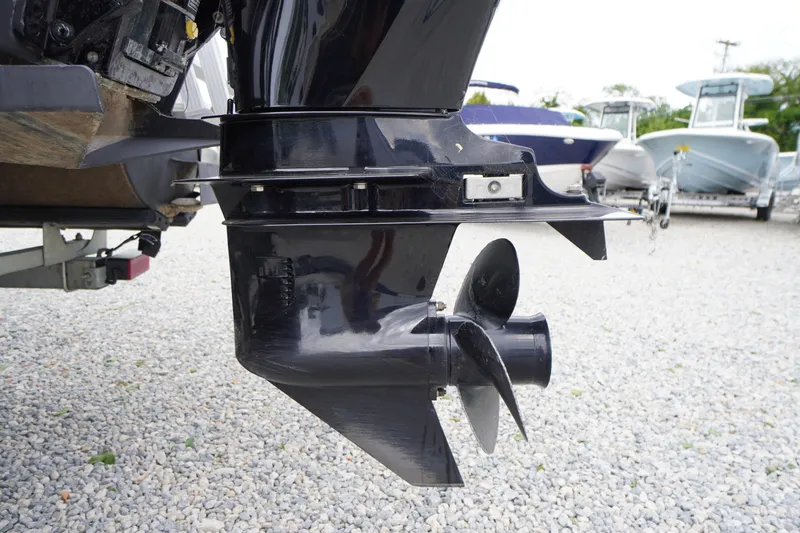 Slide: The Image of 2023 Bennington S 18 Fishing boat motor and propeller on gravel lot. - 11