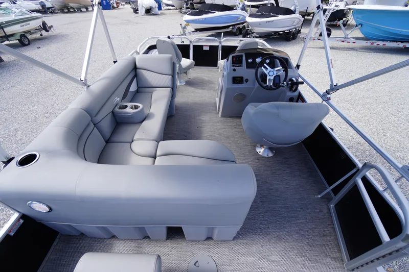 Slide: The Image of 2023 Bennington S 18 Fishing boat interior with gray seating and steering console. - 19