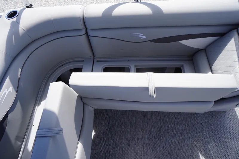 Slide: The Image of 2023 Bennington S 18 Fishing boat interior with gray seating and storage compartments. - 21