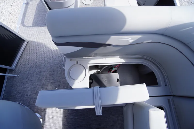 Slide: The Image of 2023 Bennington S 18 Fishing boat interior with storage compartment and cup holder. - 22
