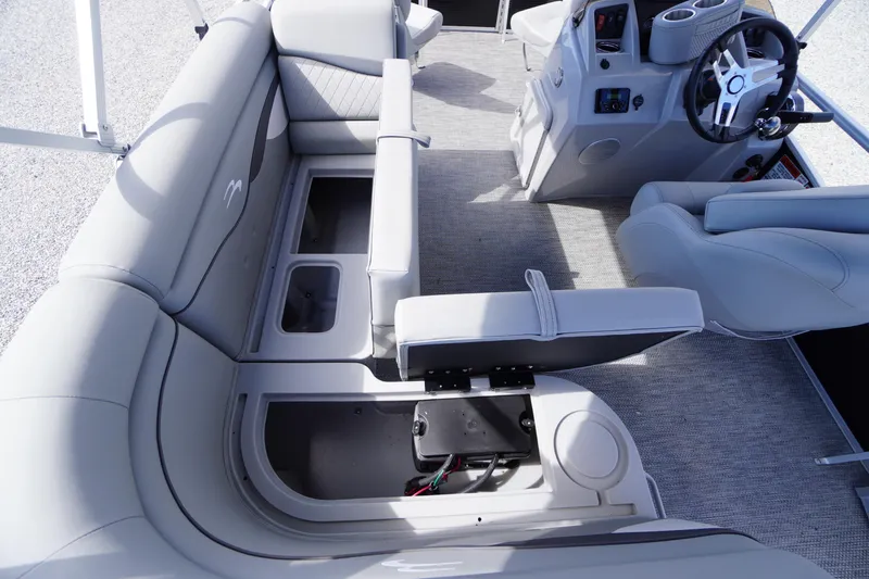 Slide: The Image of 2023 Bennington S 18 Fishing boat interior with storage compartments and steering console. - 24