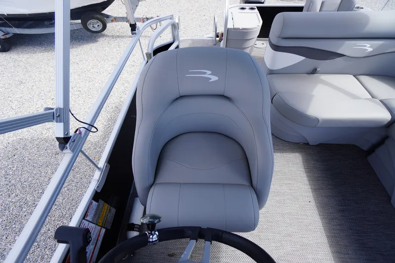 Slide: The Image of 2023 Bennington S 18 Fishing boat interior with gray seating and steering wheel. - 33