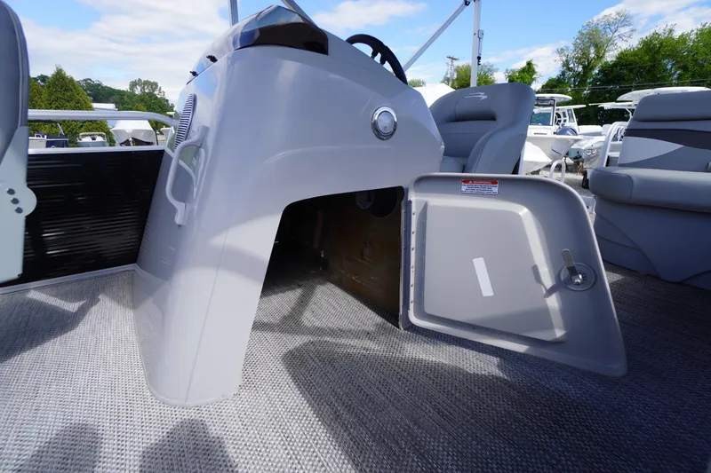 Slide: The Image of 2023 Bennington S 18 Fishing boat interior with open storage compartment and seating. - 34