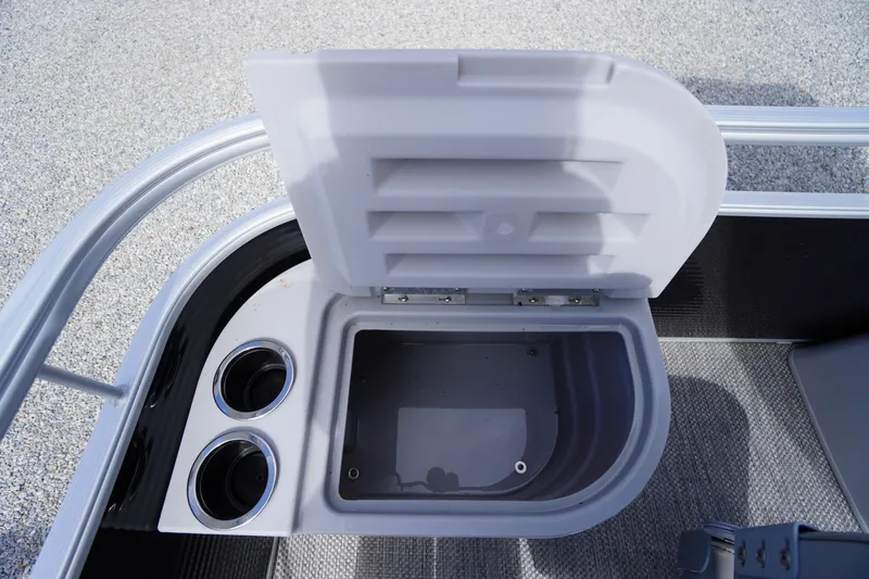 Slide: The Image of 2023 Bennington S 18 Fishing boat storage compartment with cup holders, open lid view. - 40