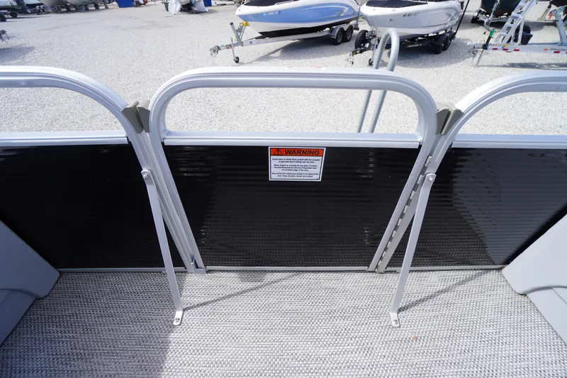 Slide: The Image of 2023 Bennington S 18 Fishing boat interior with safety gate and warning sign. - 44