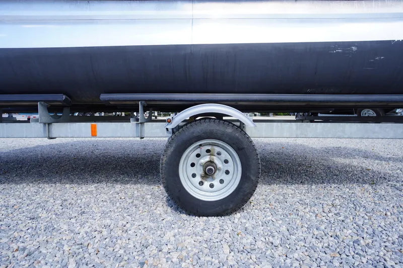 Slide: The Image of Trailer wheel of 2023 Bennington S 18 Fishing boat on gravel surface. - 45