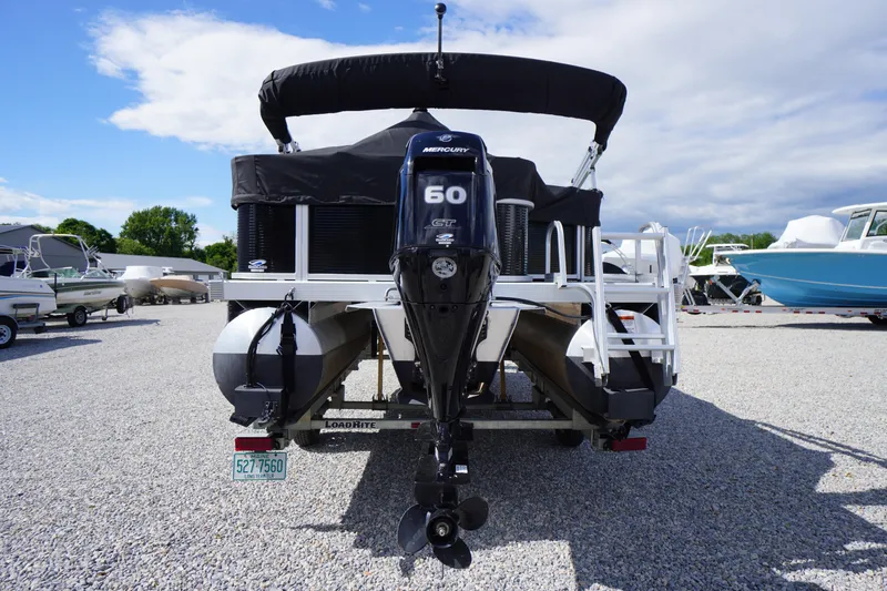 Slide: The Image of 2023 Bennington S 18 Fishing boat with Mercury 60 HP engine, parked on gravel. - 5
