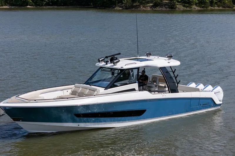 The Image of 2021 Boston Whaler 420 Outrage boat on calm water, showcasing sleek design and luxury features. - 0