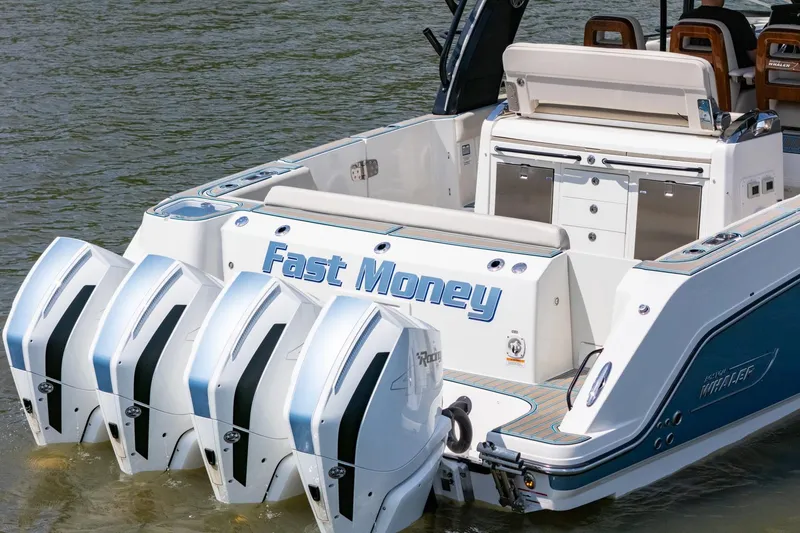 Slide: The Image of 2021 Boston Whaler 420 Outrage with quad engines, named "Fast Money," on the water. - 10