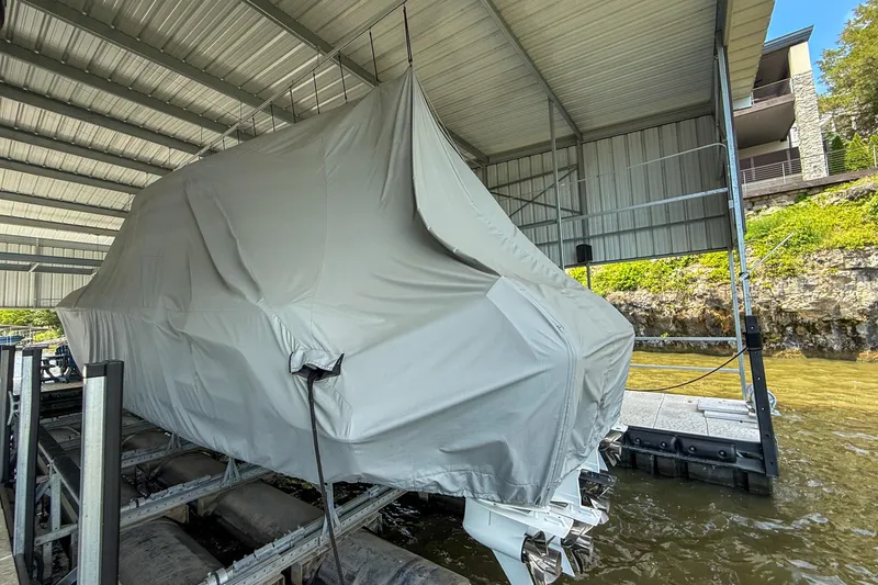 Slide: The Image of Covered 2021 Boston Whaler 420 Outrage boat in docked storage under a metal roof. - 12