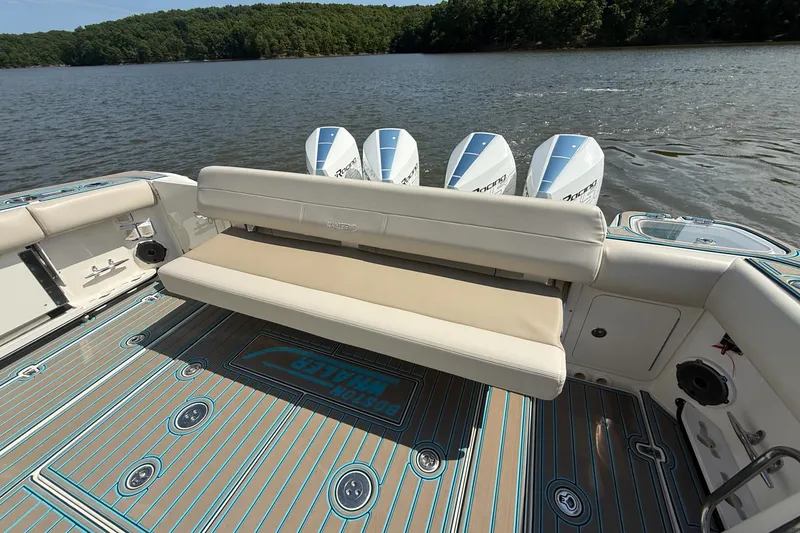 Slide: The Image of 2021 Boston Whaler 420 Outrage boat with cushioned seating and four outboard engines. - 13