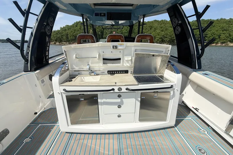 Slide: The Image of 2021 Boston Whaler 420 Outrage boat with outdoor kitchen setup on deck. - 15