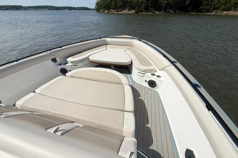 Slide: The Image of 2021 Boston Whaler 420 Outrage boat interior with cushioned seating on a calm lake. - 17