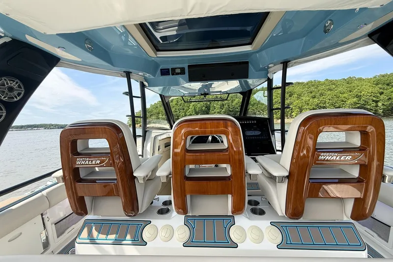 Slide: The Image of Interior view of 2021 Boston Whaler 420 Outrage boat with luxurious seating and controls. - 19