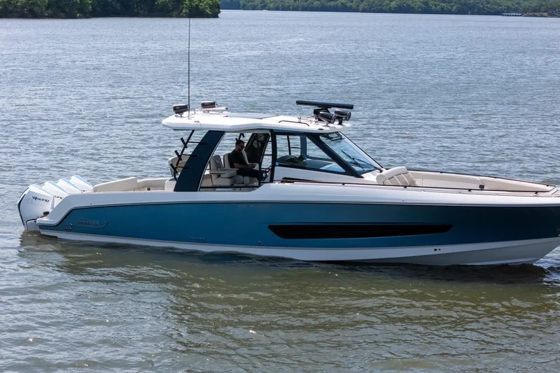 Slide: The Image of 2021 Boston Whaler 420 Outrage boat on calm water, side view. - 2