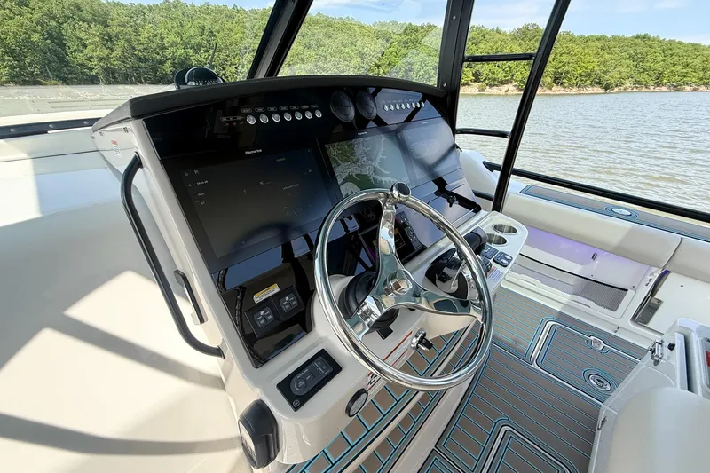 Slide: The Image of Helm of 2021 Boston Whaler 420 Outrage with advanced navigation system and sleek design. - 20