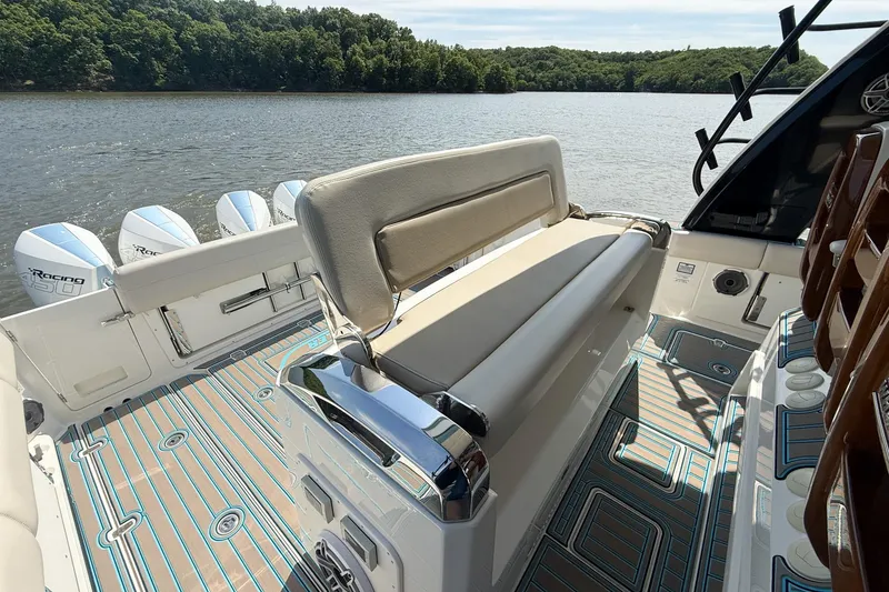 Slide: The Image of 2021 Boston Whaler 420 Outrage boat interior with seating and powerful engines on a scenic lake. - 21