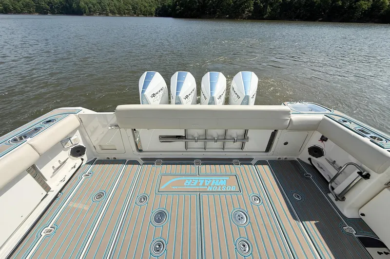 Slide: The Image of 2021 Boston Whaler 420 Outrage boat deck with four engines on a calm lake. - 23