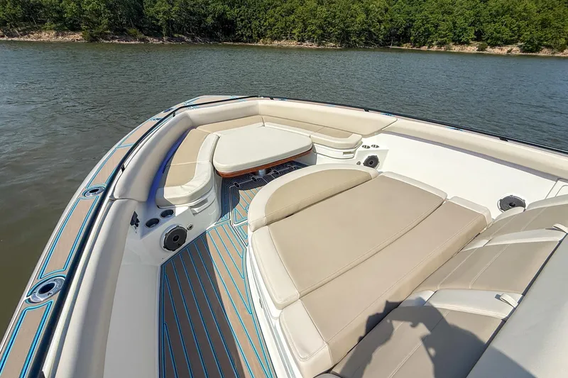 Slide: The Image of 2021 Boston Whaler 420 Outrage boat interior with luxurious seating on a calm lake. - 25