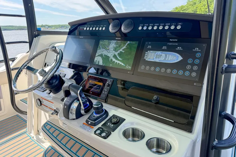 Slide: The Image of Control panel of 2021 Boston Whaler 420 Outrage with advanced navigation displays. - 27