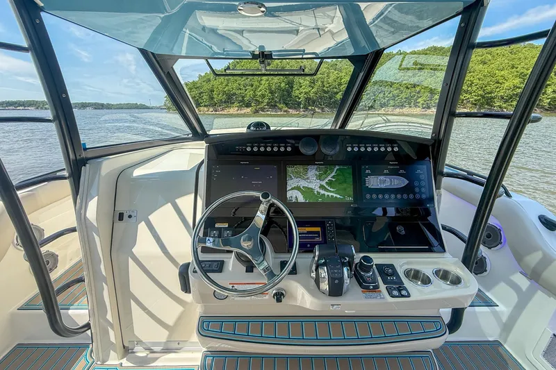 Slide: The Image of Helm of 2021 Boston Whaler 420 Outrage with advanced navigation systems on a scenic waterway. - 29