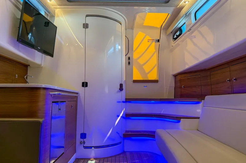 Slide: The Image of Luxurious interior of 2021 Boston Whaler 420 Outrage with modern amenities and ambient lighting. - 30