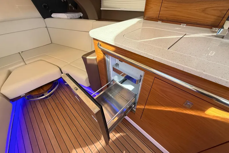 Slide: The Image of Luxurious interior of 2021 Boston Whaler 420 Outrage with open drawer and seating area. - 32