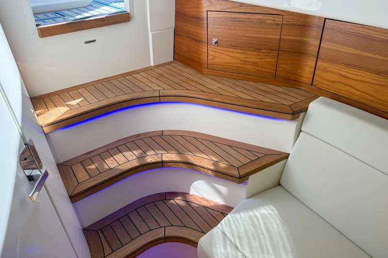Slide: The Image of Luxurious interior of 2021 Boston Whaler 420 Outrage with elegant wooden steps and ambient lighting. - 37