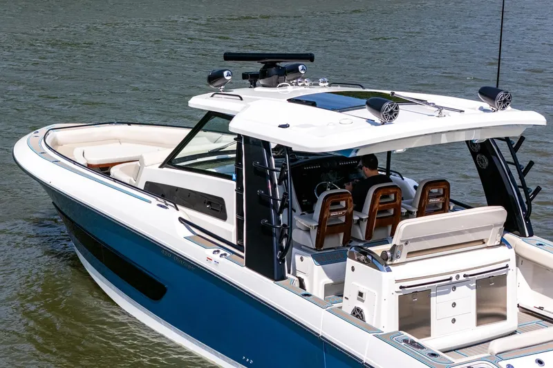 Slide: The Image of 2021 Boston Whaler 420 Outrage boat cruising on water, showcasing luxury design and spacious seating. - 4