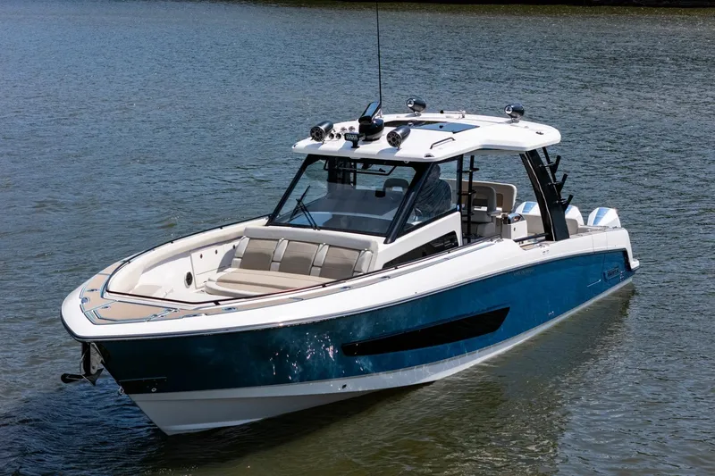 Slide: The Image of 2021 Boston Whaler 420 Outrage boat on calm water, showcasing sleek design and luxury features. - 40