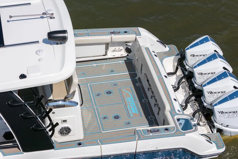 Slide: The Image of 2021 Boston Whaler 420 Outrage boat with quad Racing engines, featuring spacious deck design. - 6