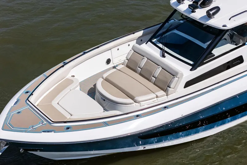 Slide: The Image of 2021 Boston Whaler 420 Outrage boat with luxurious seating on calm water. - 9