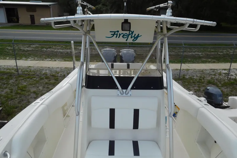 Slide: The Image of 2003 Hydra-Sports Vector 2800 CC boat interior with seating and T-top, labeled "Firefly." - 6