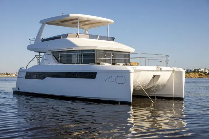 Slide: The Image of Manufacturer Provided Image: 2025 Leopard 40 Powercat yacht on calm water, showcasing modern design and spacious deck. - 1