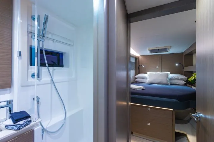 Slide: The Image of Manufacturer Provided Image: Luxurious interior of 2025 Leopard 40 Powercat featuring a cozy bedroom and modern bathroom. - 18
