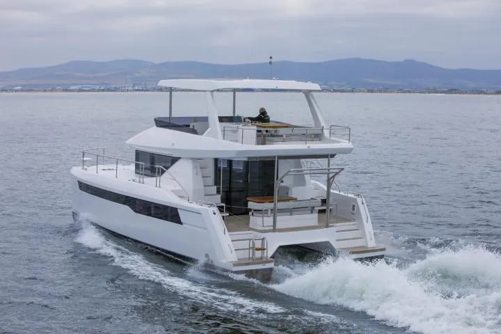 Slide: The Image of Manufacturer Provided Image: 2025 Leopard 40 Powercat cruising on open water with scenic mountain backdrop. - 5