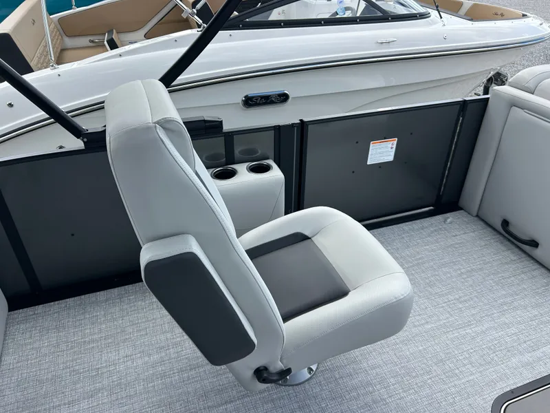 Slide: The Image of A modern boat seat with gray upholstery and black accent on a Harris Cruiser 230. - 13