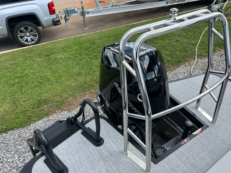 Slide: The Image of A 2027 Harris Cruiser 230 with a sleek outboard motor and sturdy stainless steel frame. - 8