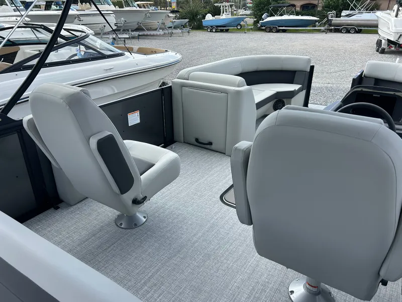 Slide: The Image of The image shows the interior of a 2027 Harris Cruiser 230 with gray seats and carpeted flooring. - 11