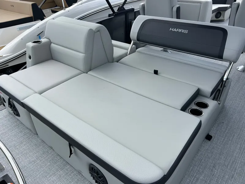 Slide: The Image of The image shows the gray upholstered seats of a 2027 Harris Cruiser 230 with cup holders. - 9