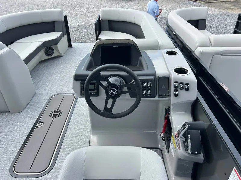 Slide: The Image of The image shows the cockpit of a 2027 Harris Cruiser 230 with a modern helm station. - 12