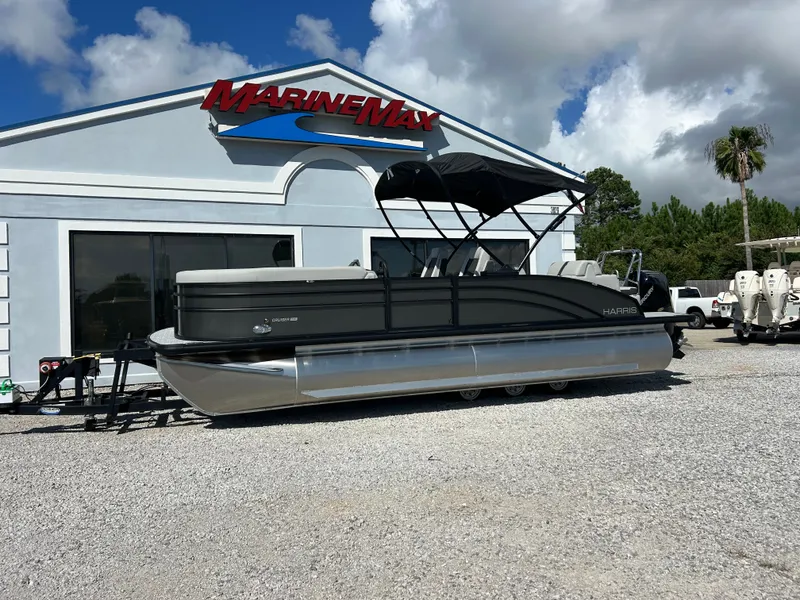 Slide: The Image of A 2027 Harris Cruiser 230 pontoon boat on a trailer in front of a MarineMax building. - 5