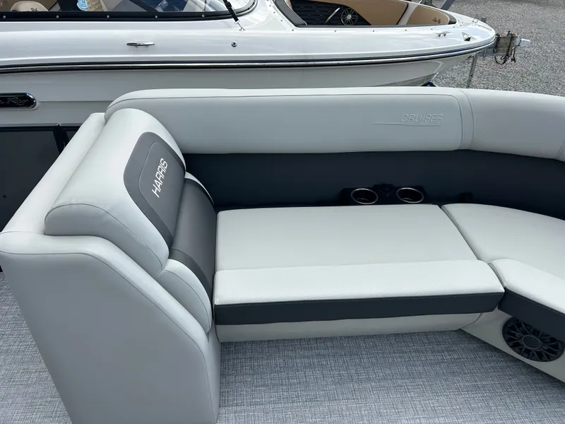 Slide: The Image of The image shows the seating area of a 2027 Harris Cruiser 230 with gray upholstery and cup holders. - 18