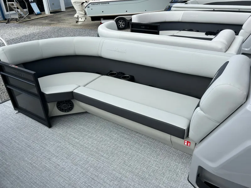 Slide: The Image of The image shows the seating area of a 2027 Harris Cruiser 230 with gray upholstery. - 16
