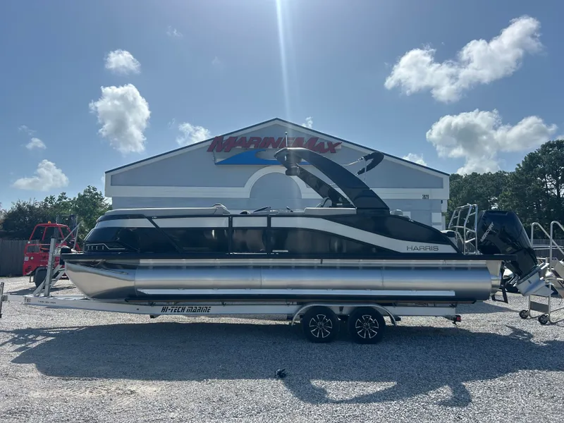 Slide: The Image of A 2027 Harris Grand Mariner 250 on a trailer in front of a building. - 6