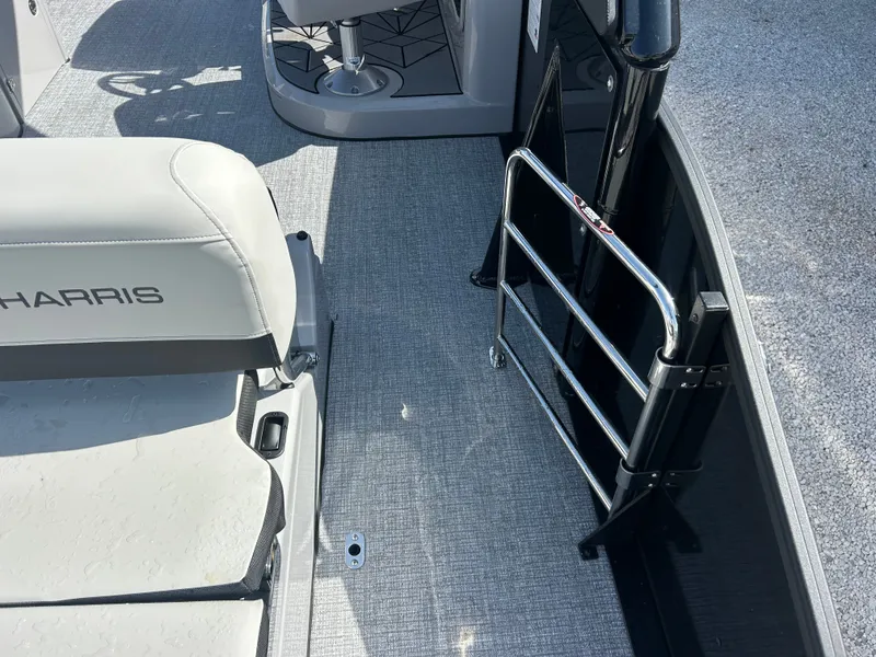 Slide: The Image of The image shows the interior of a 2027 Harris Grand Mariner 250 with gray carpeting and white seating. - 15