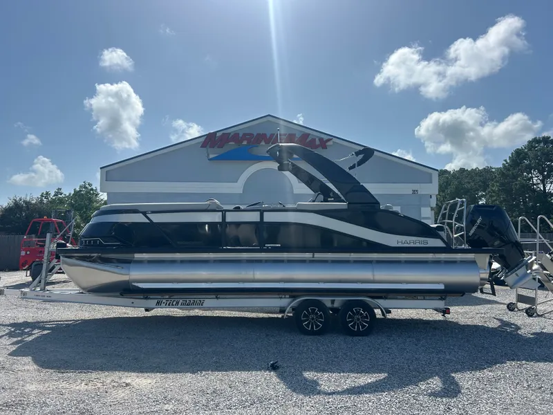 Slide: The Image of A 2027 Harris Grand Mariner 250 on a trailer in front of a building. - 5