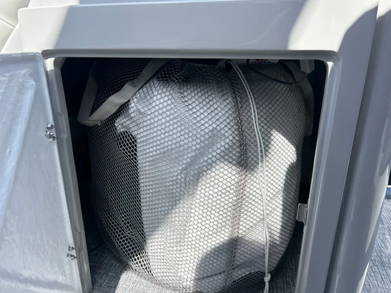 Slide: The Image of A mesh bag with items is stored in a compartment on a boat. - 20